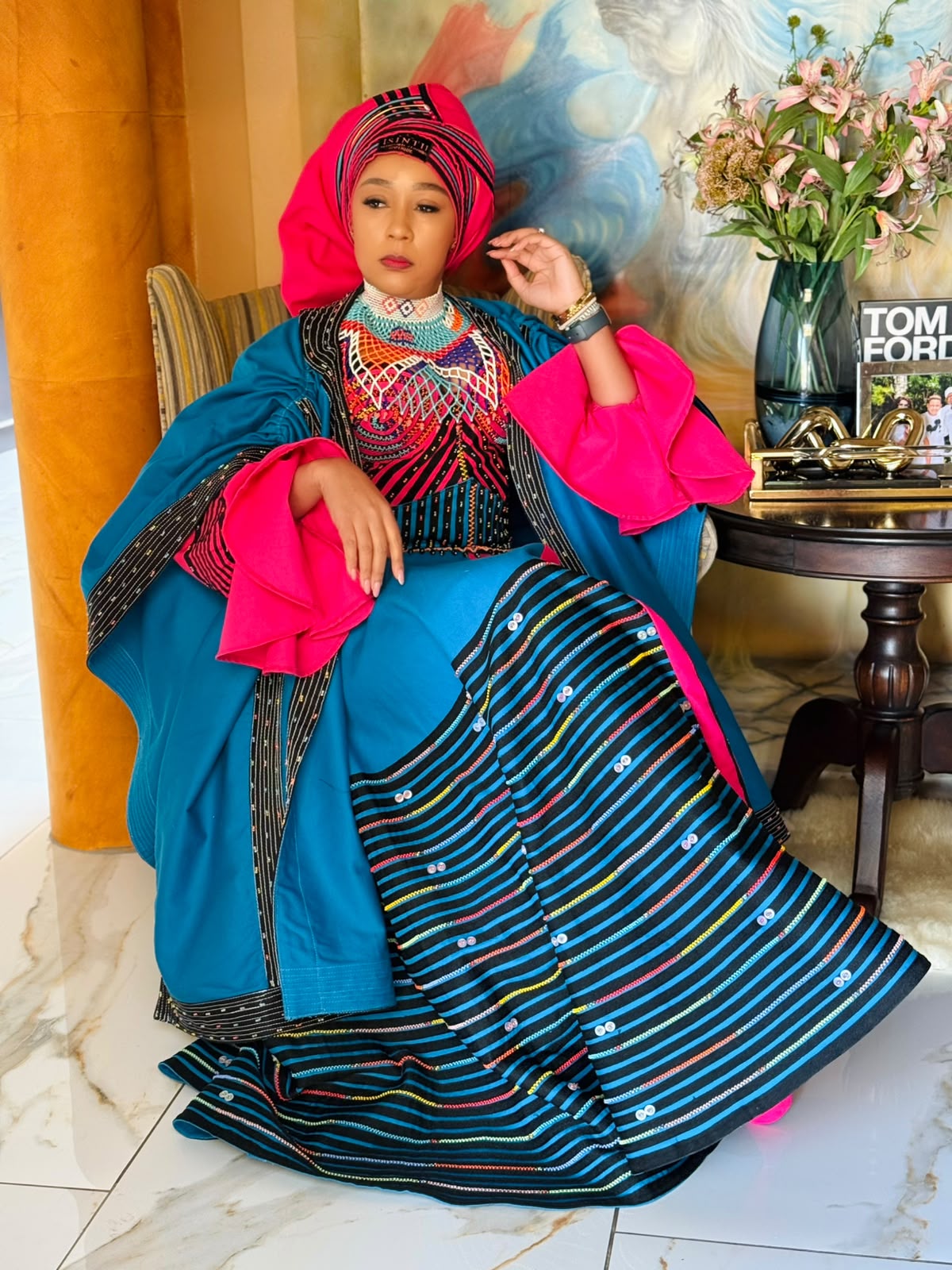 Buli posing in teal and pink Xhosa gown